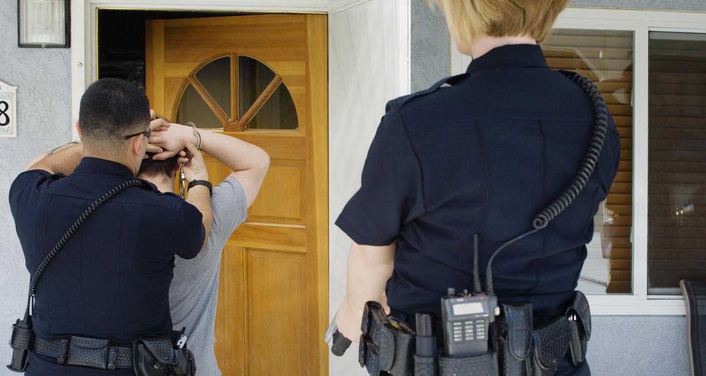 Law Enforcement arresting burglar after home burglary